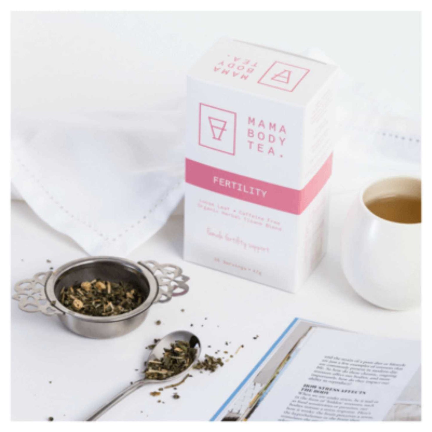 An elegant white dish and mug containing fertility tea from Mama Body Tea, showcasing the nourishing blend of herbs inside that are preconception helping balance hormones. tea includes, Organic Raspberry Dong, Quai Root, Shativari Root, Tulsi, Skullcap