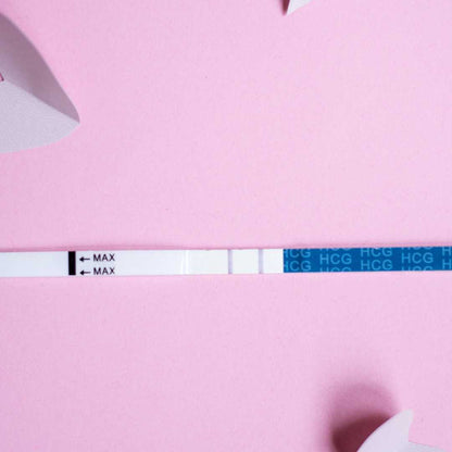 Positive HCG test strip indicating pregnancy